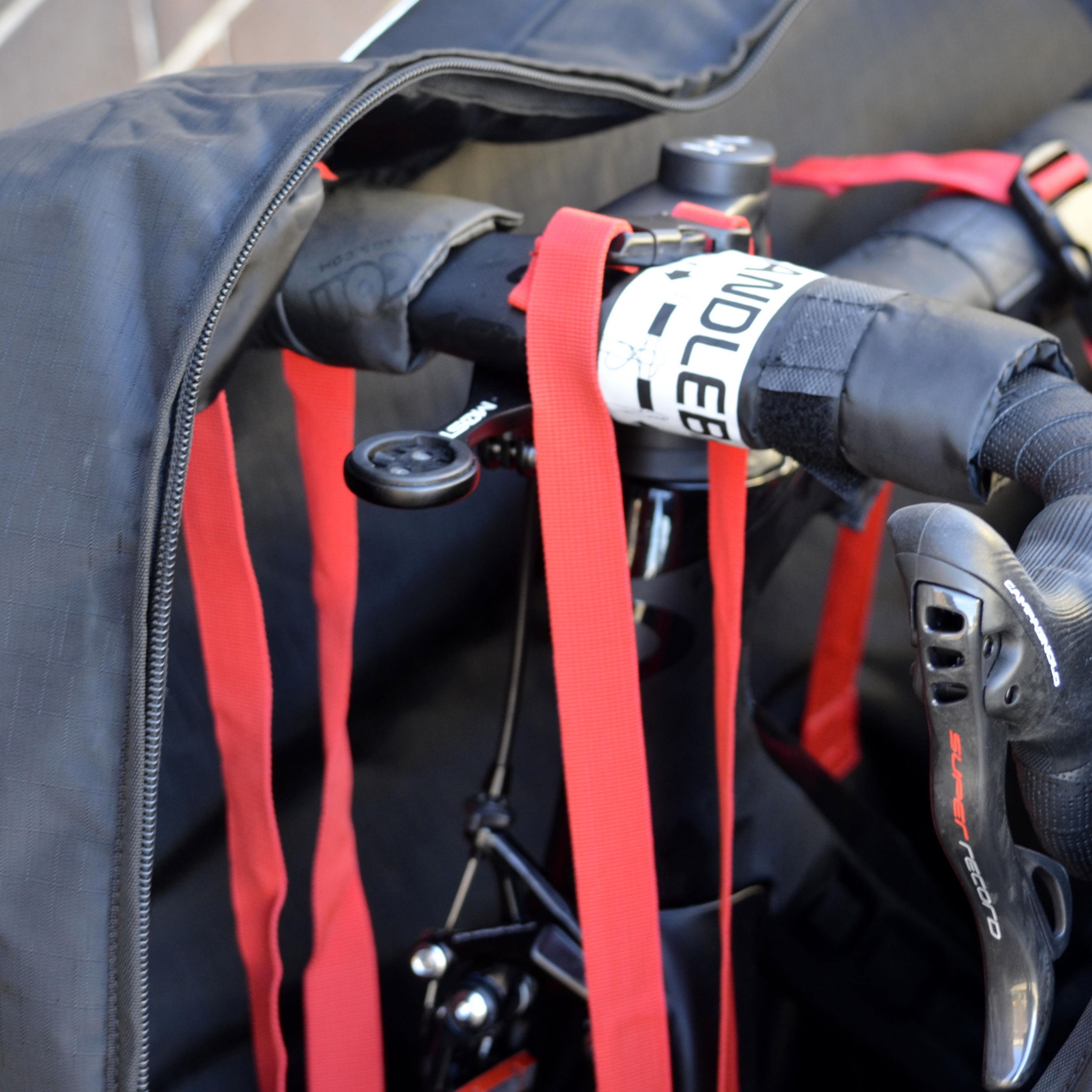 The interior support structure and straps of a road-bike travel bag